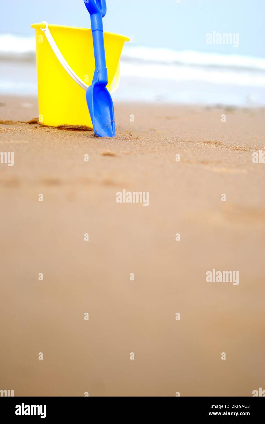 Yellow bucket spade on beach hi-res stock photography and images - Alamy