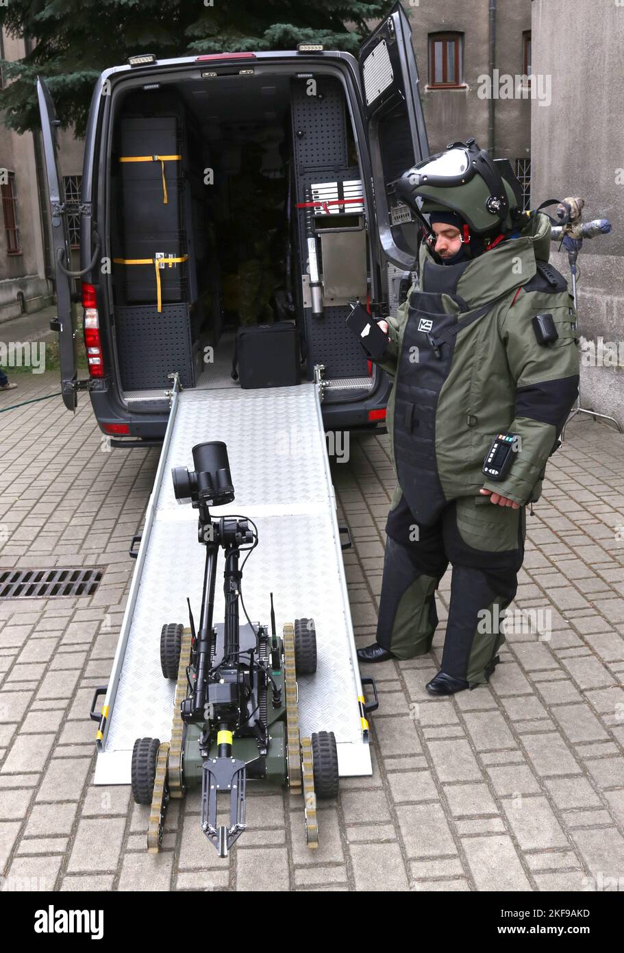 Crcaow. Krakow. Poland. Remote bomb disposal robot used by police and officer wearing  heavy blast suit. Stock Photo