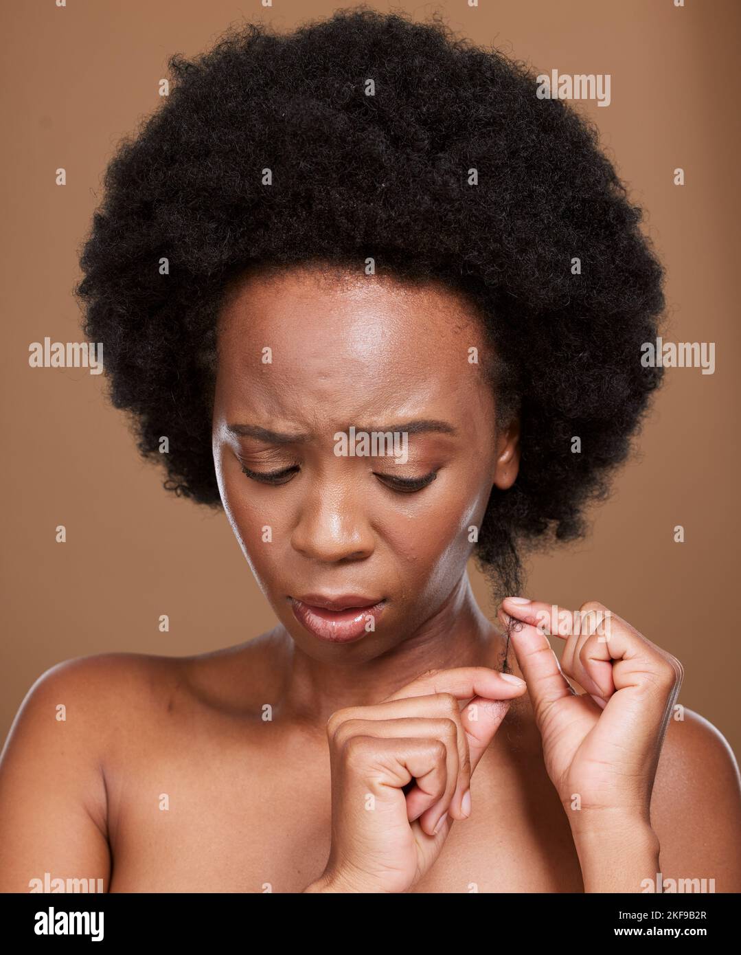 Hair loss, stress and black woman feeling anxious about hairstyle damage and dry hair care. Hair style, afro and split end control problem of a woman Stock Photo