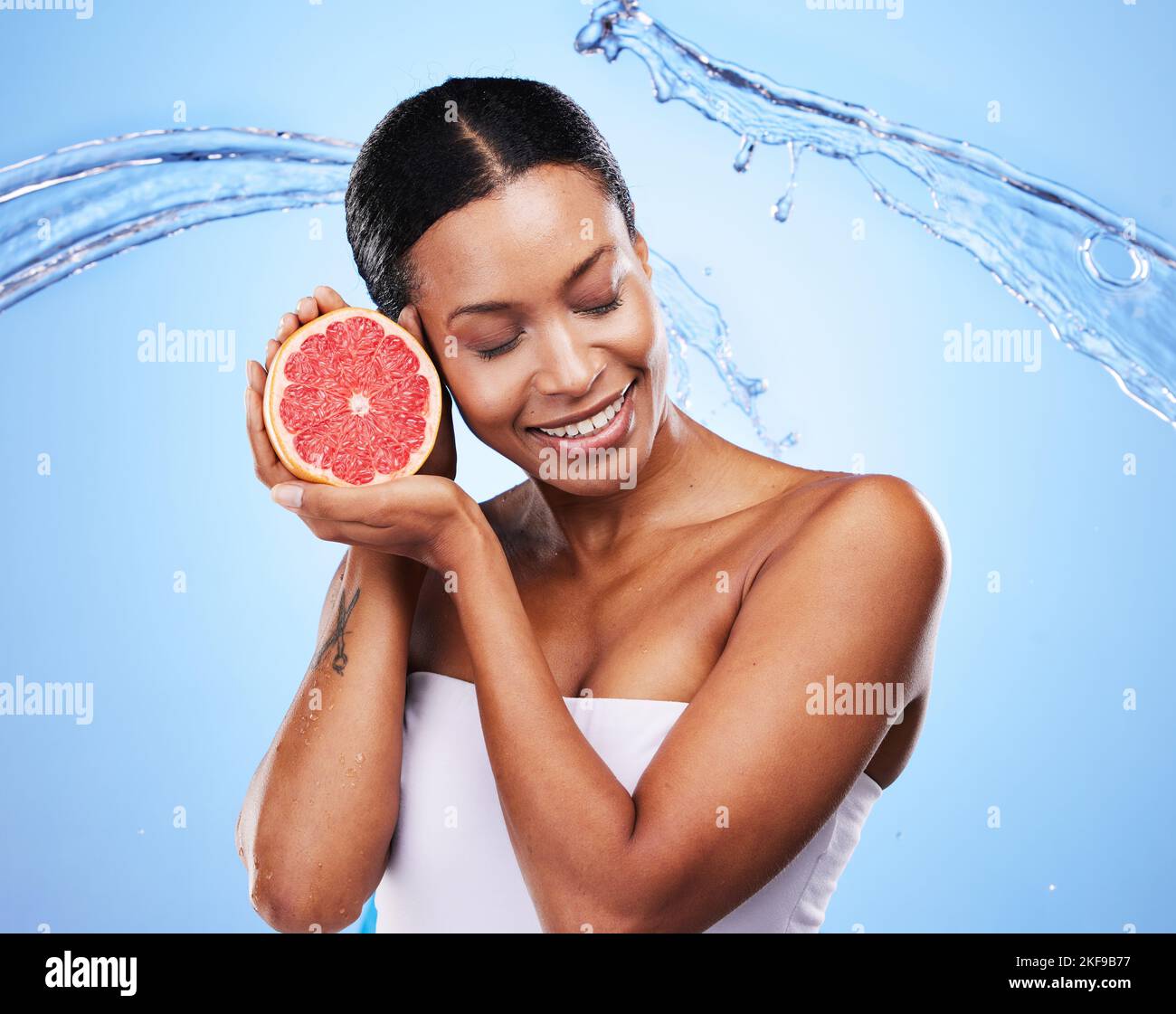 Water splash, grapefruit and skincare of a black woman holding fruit, diet food and nutrition. Vitamin c, cosmetic health and wellness of a model with Stock Photo