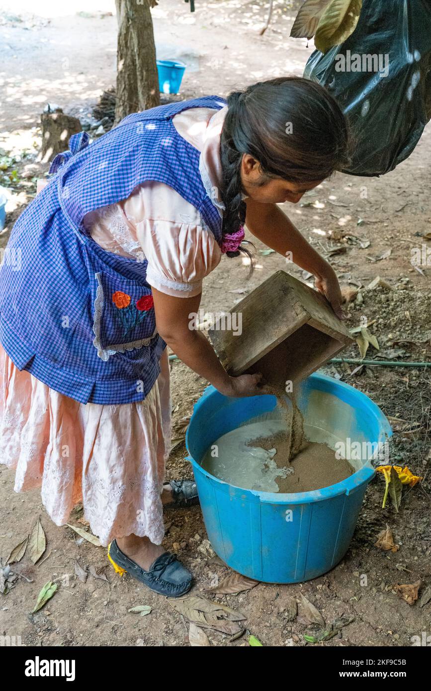 Making red clay pottery. Potter mixing red dirt with the clay for color