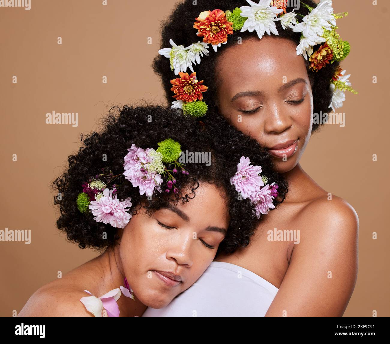 Beauty, flowers and black women with diversity calm from skincare, skin health glow and cosmetics. Model together with flower and plant based facial Stock Photo