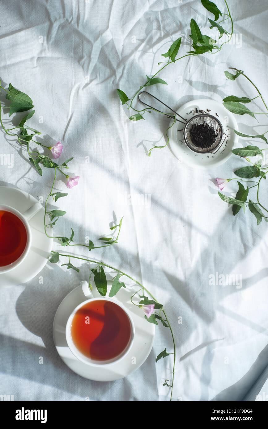 Spring teatime, rustic flatlay, tea cups from above on a wrinkled cloth background with copy space Stock Photo