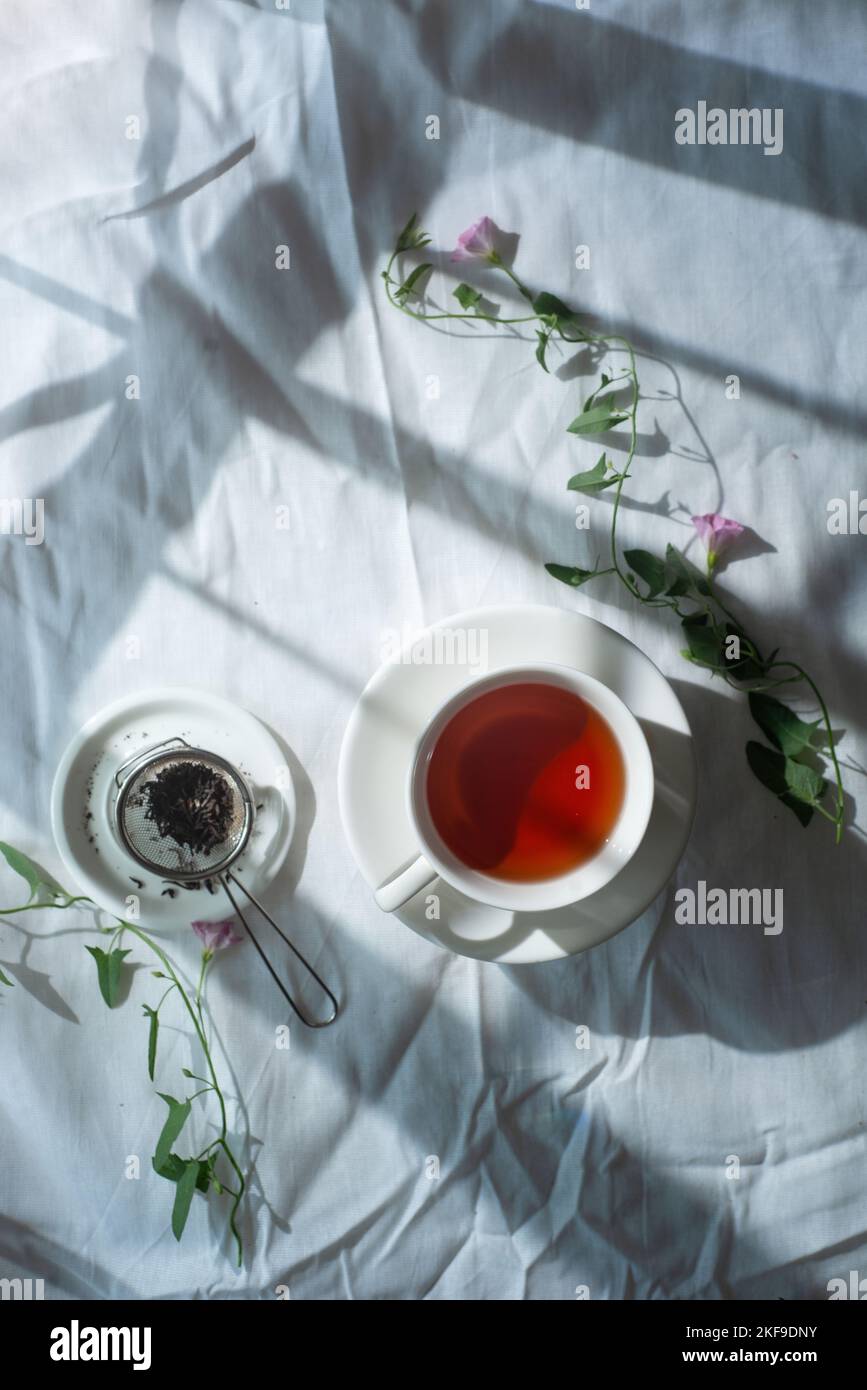 Spring teatime, rustic flatlay, tea cups from above on a wrinkled cloth background with copy space Stock Photo