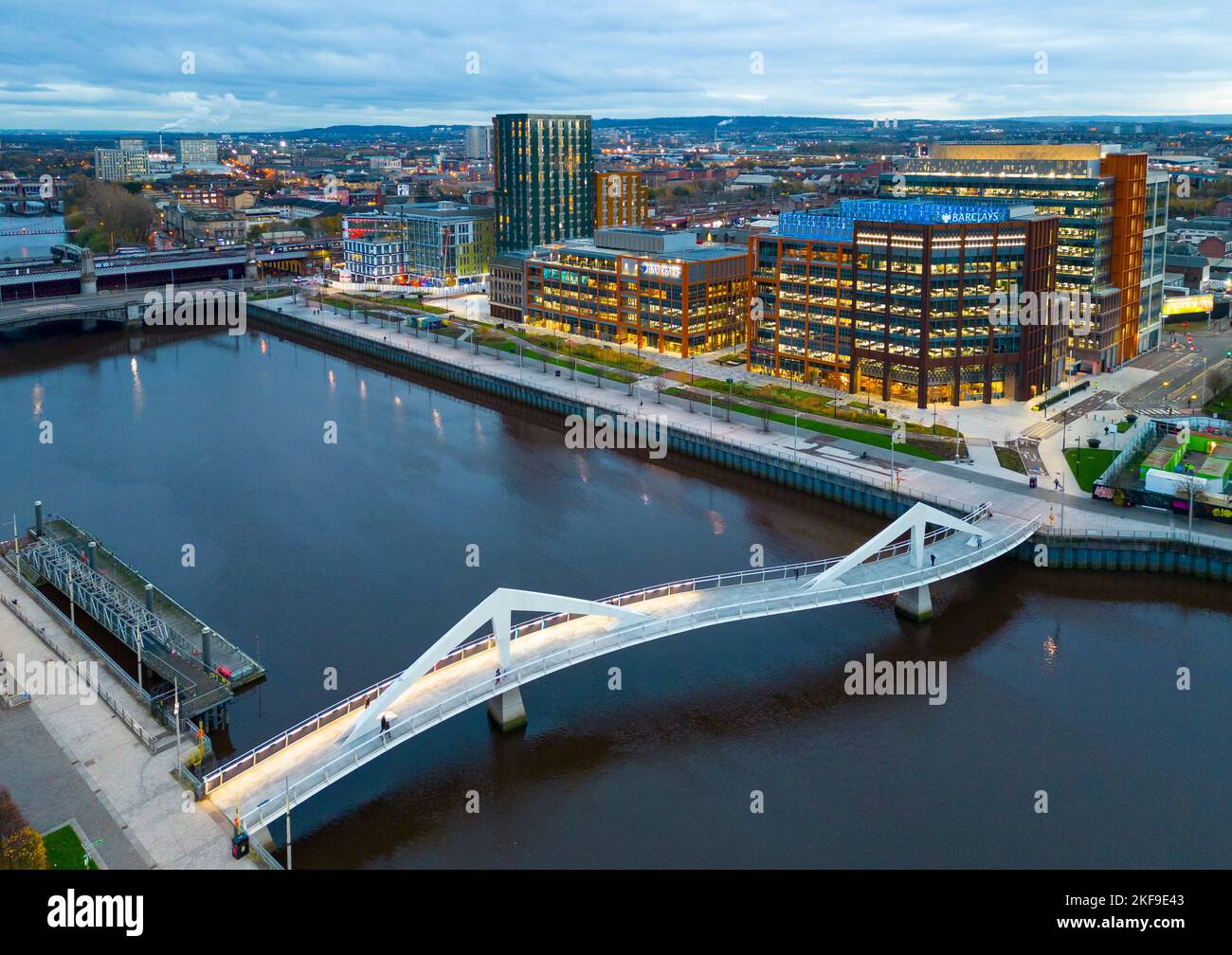 Aerial view from drone at dusk of Squiggly Bridge and Barclays campus in Tradeston beside River Clyde, Glasgow,  Scotland, UK Stock Photo