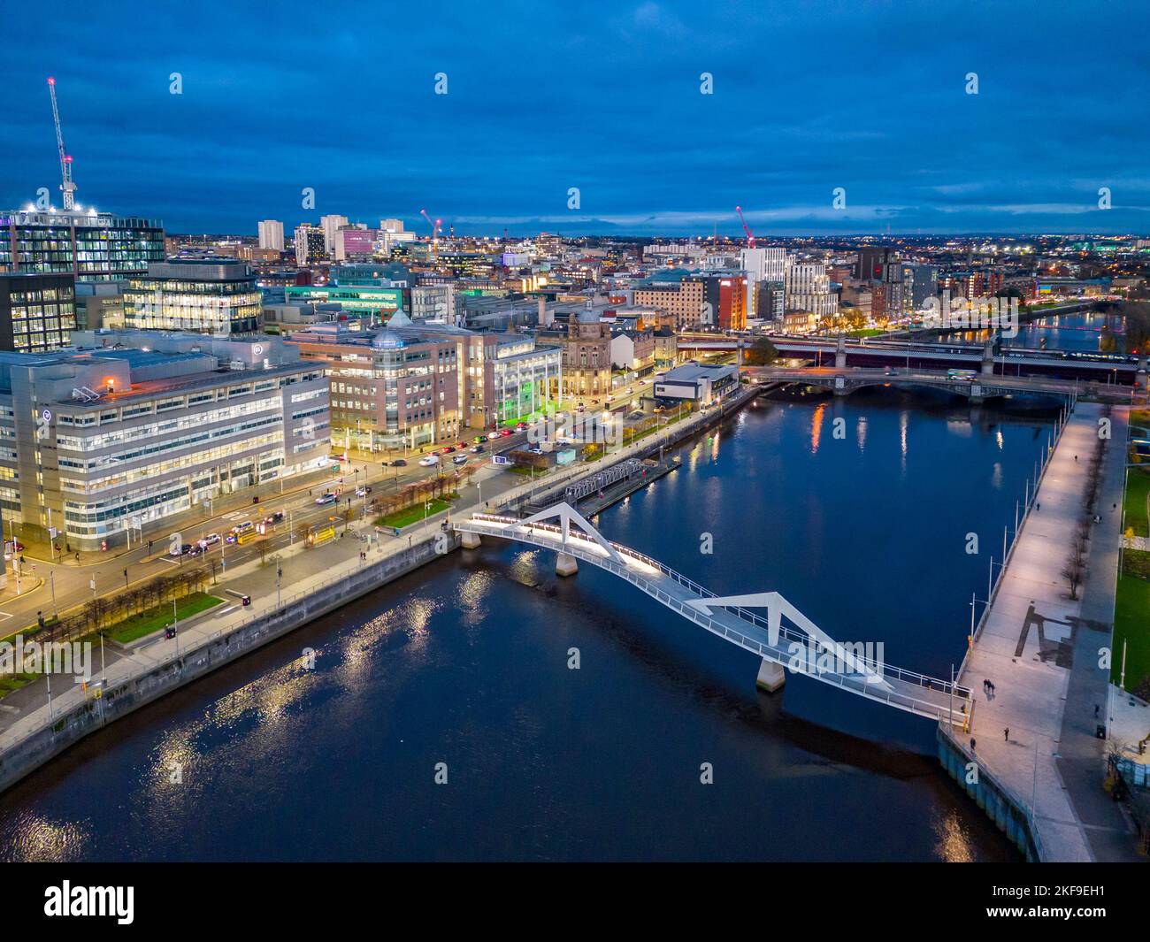 Aerial view from drone at dusk of skyline of Glasgow and Squiggly Bridge crossing River Clyde at Broomielaw, Scotland, UK Stock Photo