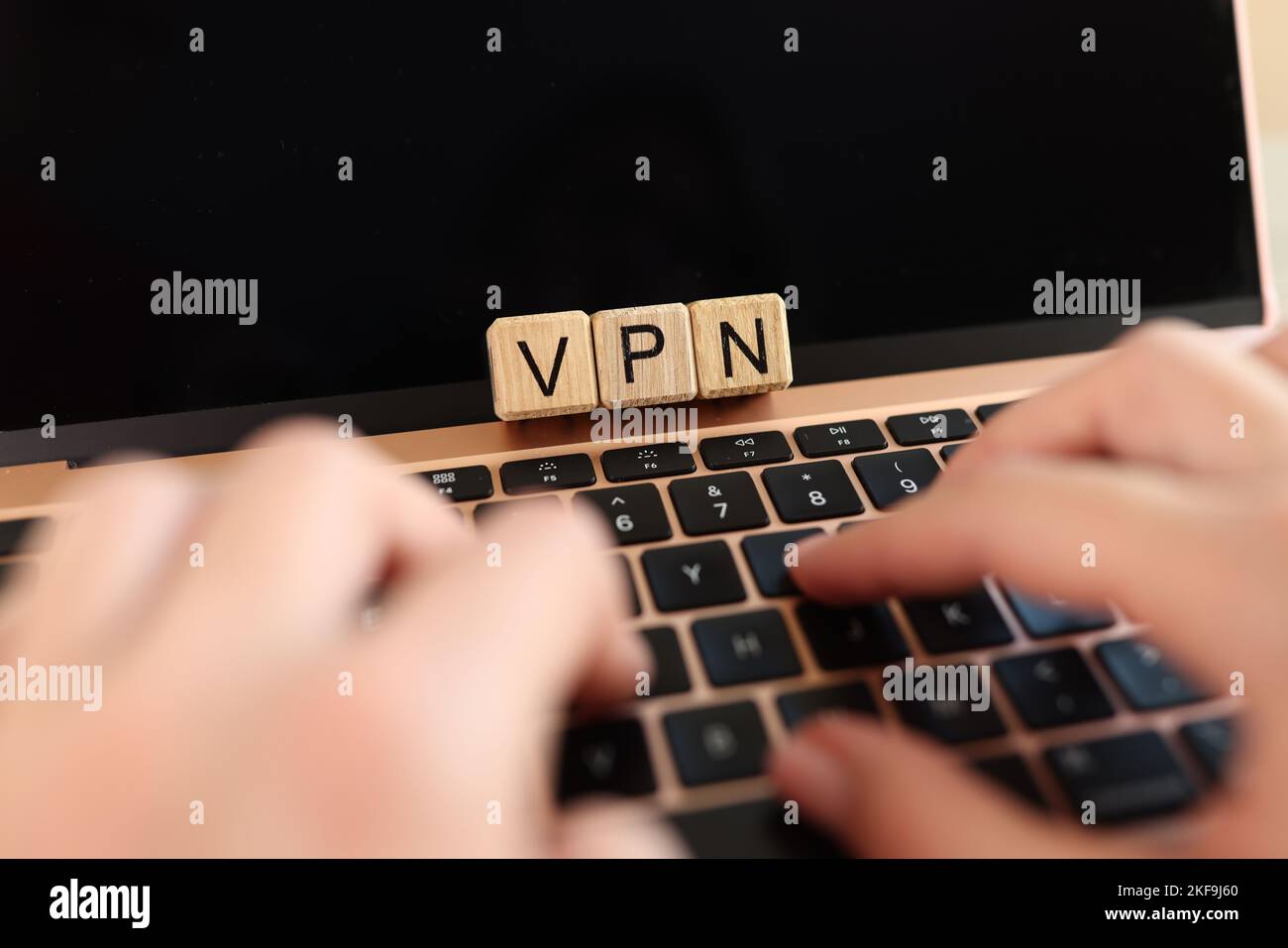 Internet user works on laptop with VPN Virtual Private Network for secure and encrypted connection. Stock Photo