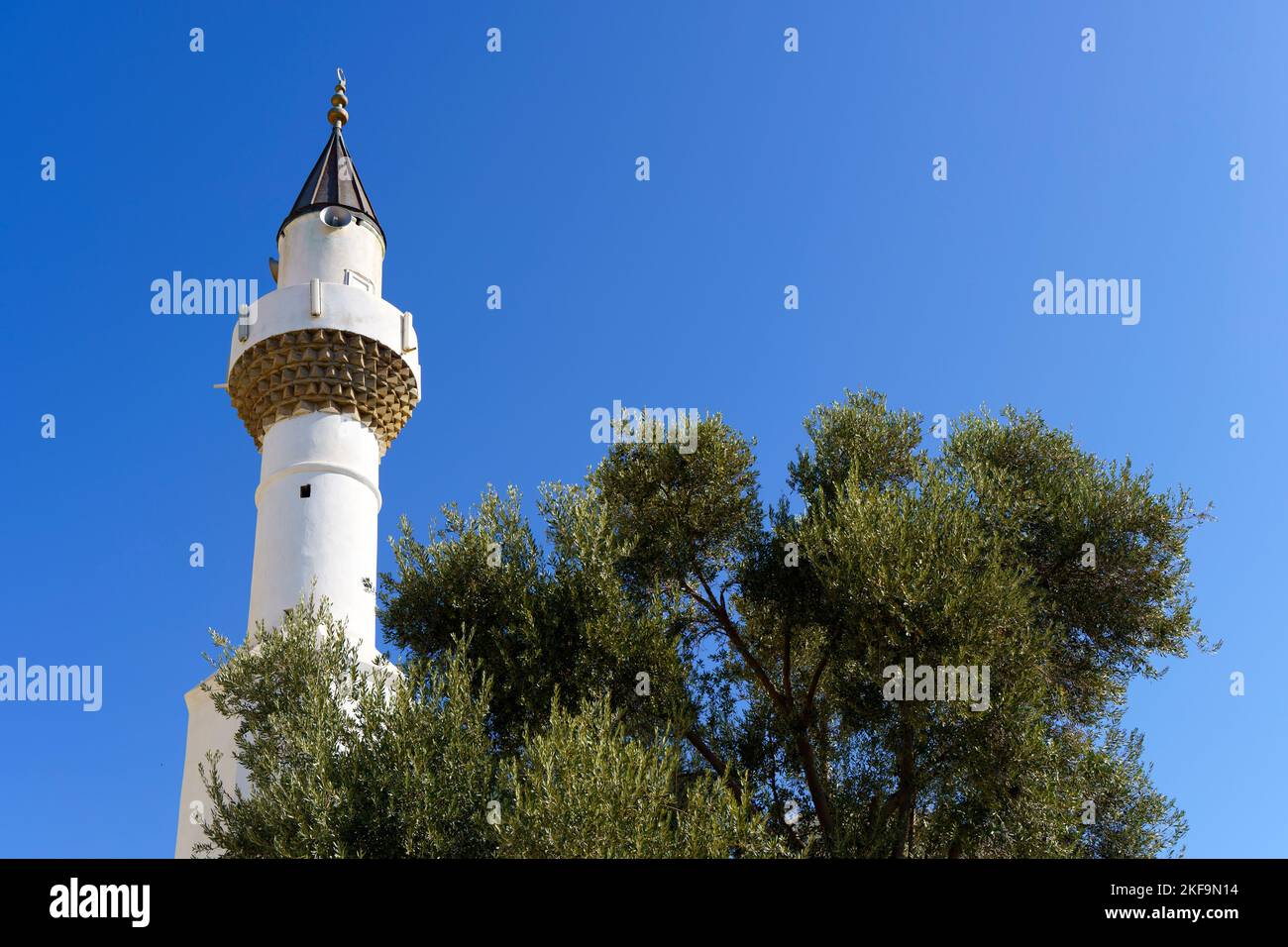Architecture of an Islamic mosque in Turkey against the backdrop of a sunny sky background. Minaret of a Muslim mosque with a blue dome. High quality photo Stock Photo