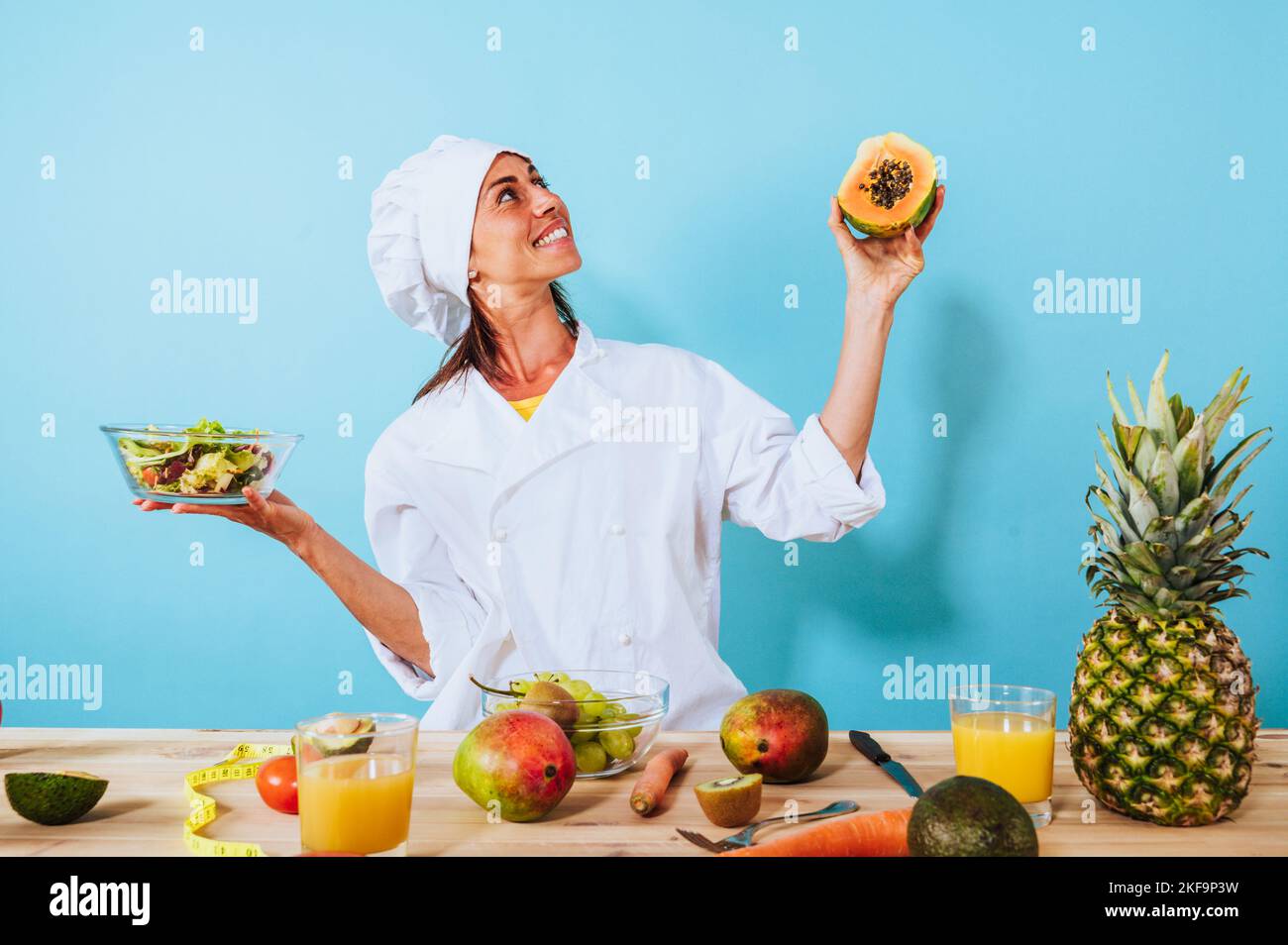Woman chef prepares a new receipt with fruits Stock Photo