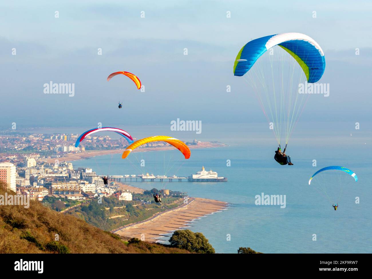 Paragliders over Beachy Head with Eastbourne in the background Stock Photo