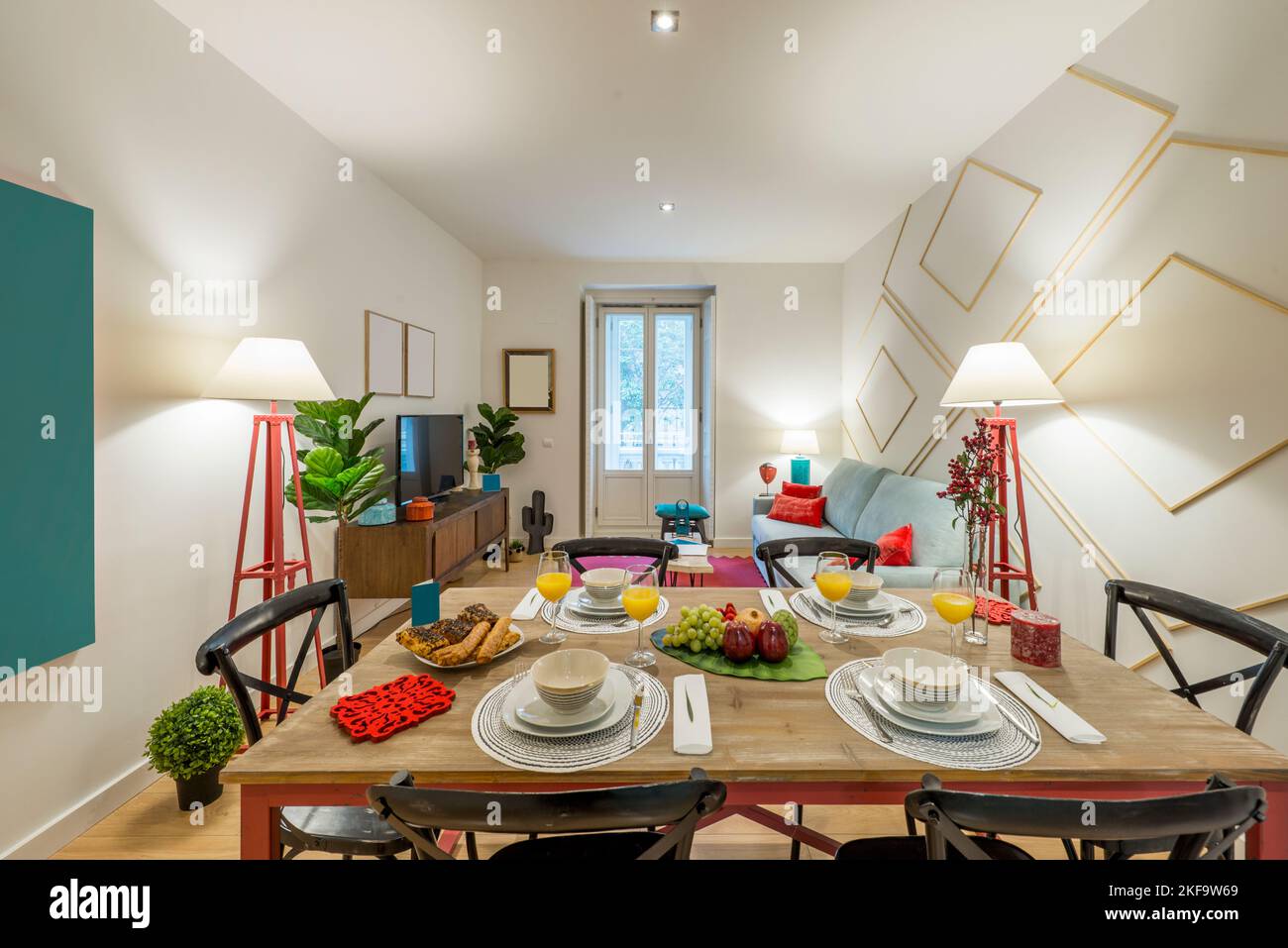 Rectangular wooden dining table with tableware set with fresh fruit ...