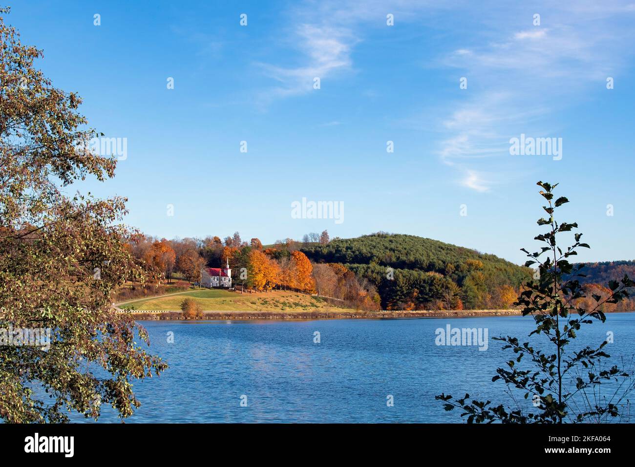 Beautiful old country church on a hillside in Appalachia overlooking a lake with negative space. Stock Photo