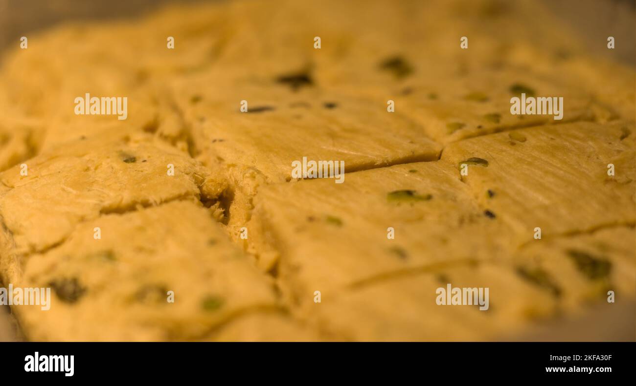 Close up of Sliced Indian Sweets, Soan Papdi inside packaging box. Stock Photo