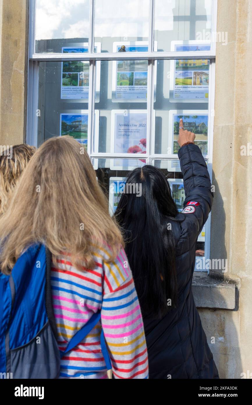 People looking into the window of an estate agents office in Bath