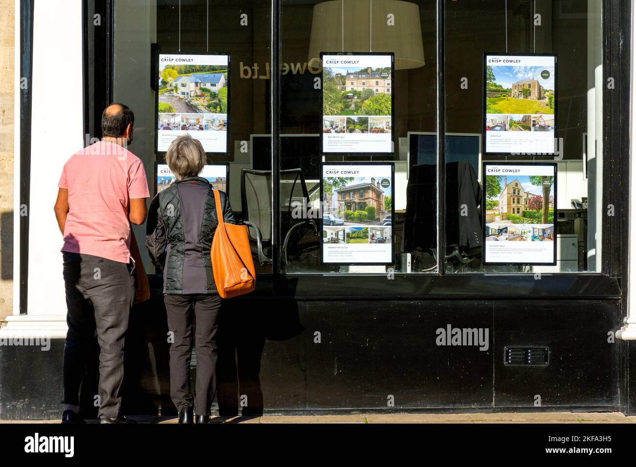 People looking into the window of an estate agents office in Bath