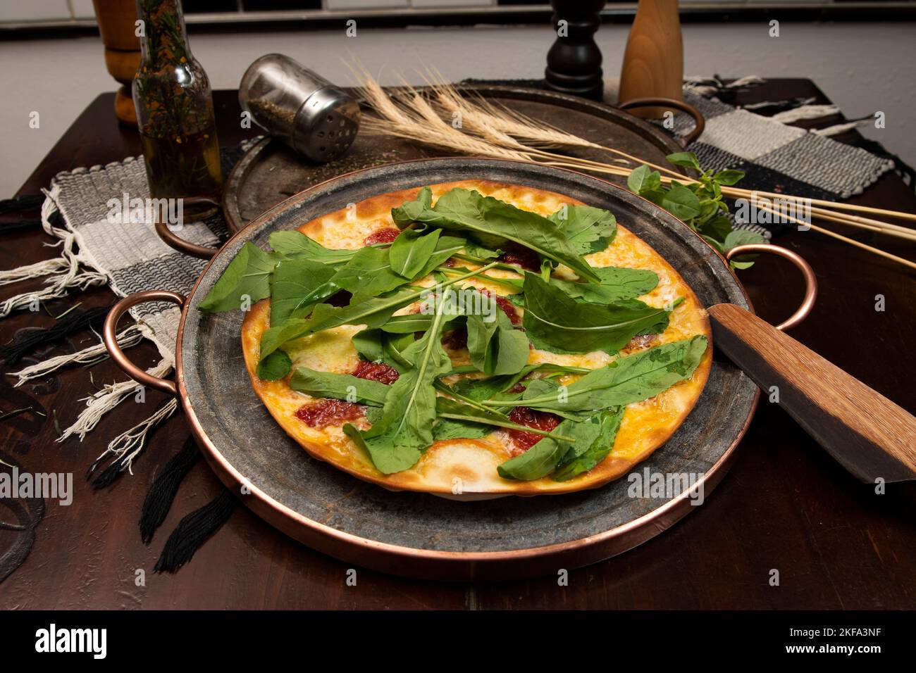 Brazilian pizza with sundried tomatoes, arugula and mozzarella