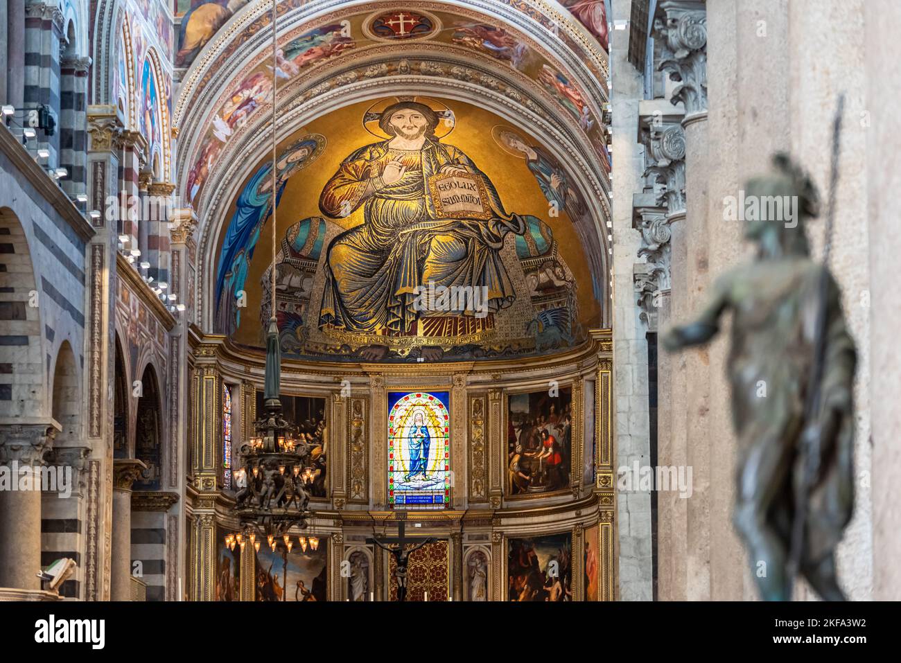 View of huge golden fresco of Jesus decorating the dome ceiling inside catholic Basilica in Pisa Stock Photo