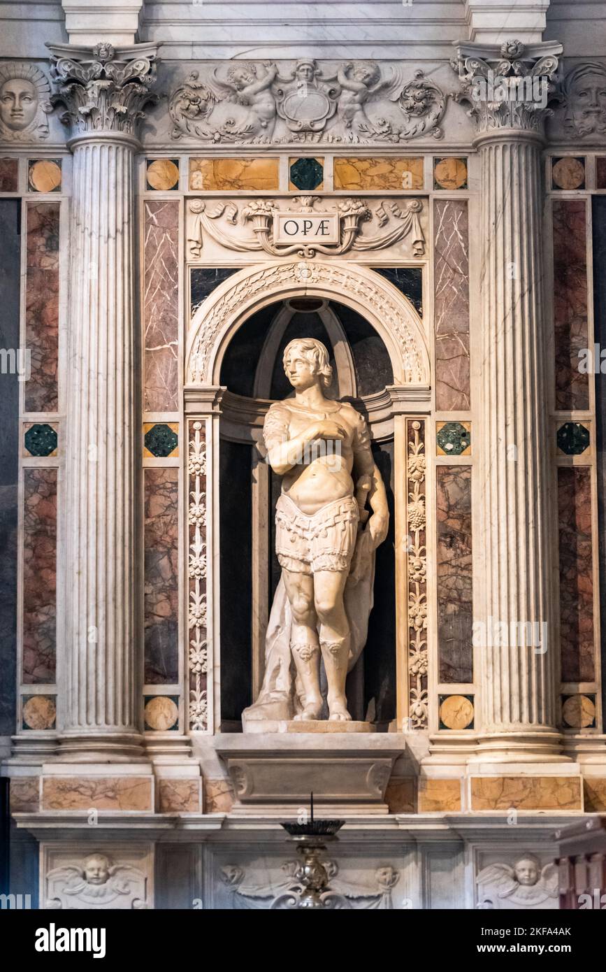 Marble statue of catholic saint decorating niche  inside basilica in Pisa Stock Photo