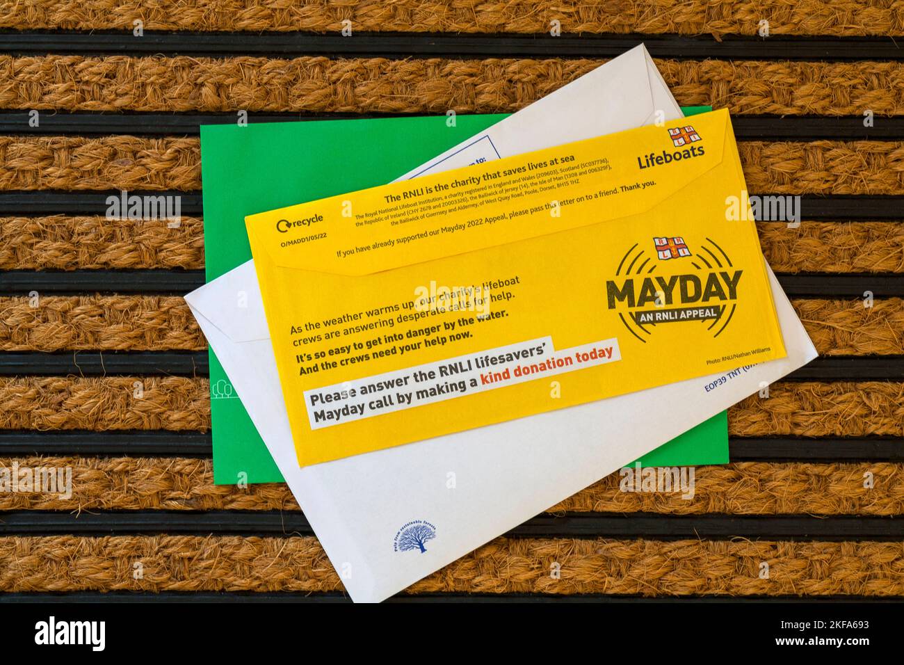 Post mail on doormat - charity appeal, RNLI Lifeboats Mayday an RNLI appeal Stock Photo