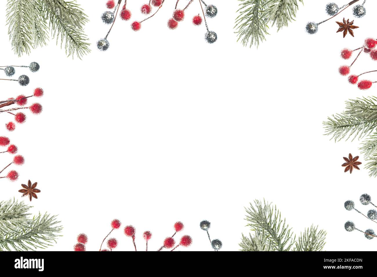 Christmas frame with fir tree branches, red berries and silver balls on ...