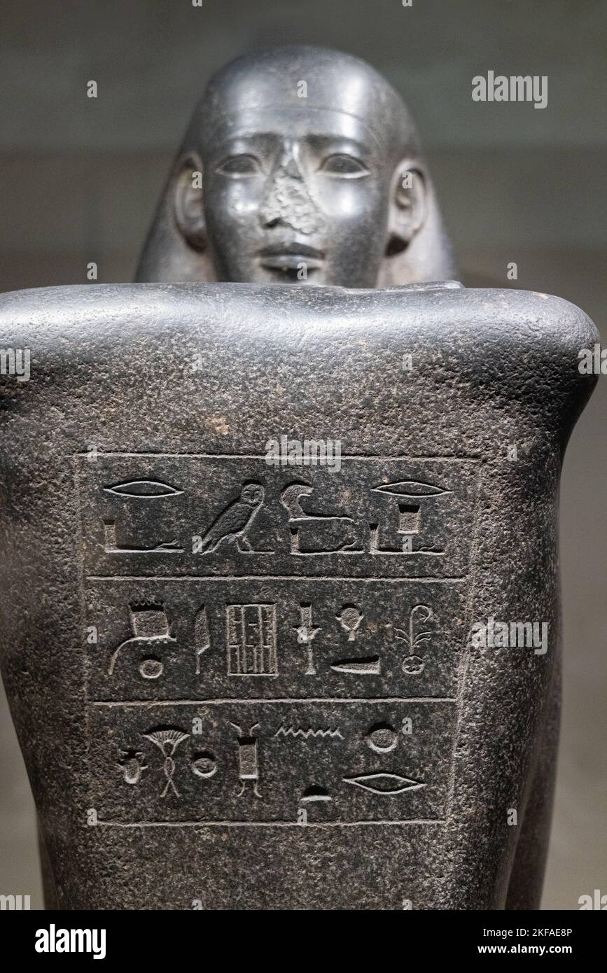 Ancient egypt statue; Block statue of a seated person with ancient egyptian hieroglyphics, Sais city, Egypt, 590-550 BC, Musee de Louvre, Paris Stock Photo