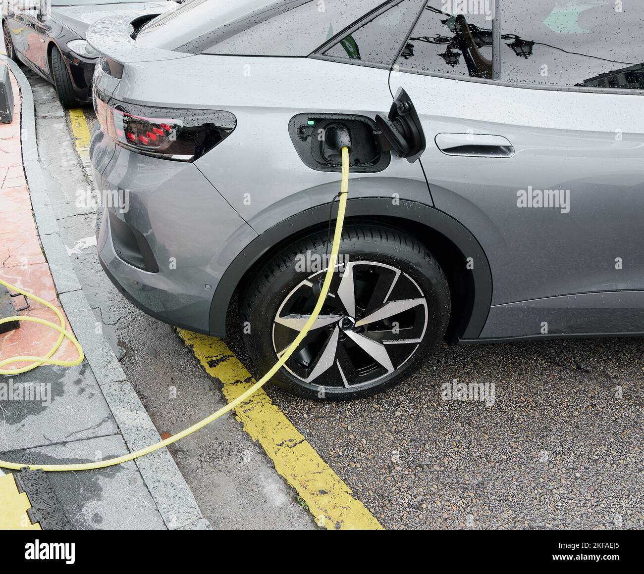 Charging station for electric vehicles in a public parking lot. Nature conservation concept by reducing CO2 emissions through alternative energy as a Stock Photo