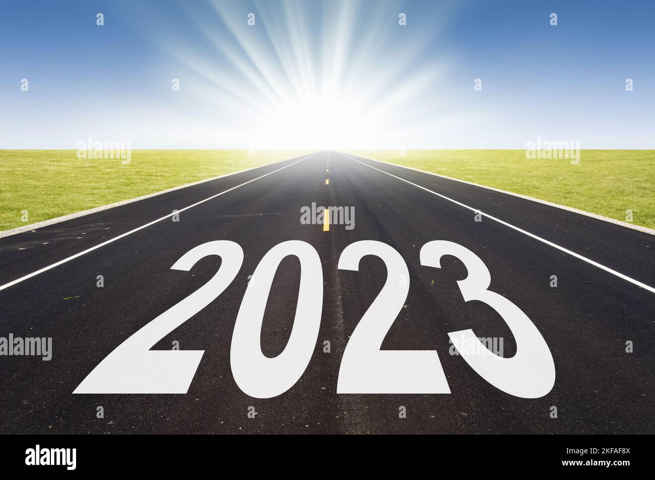 2023 road perspective with rising sun, new year card Stock Photo