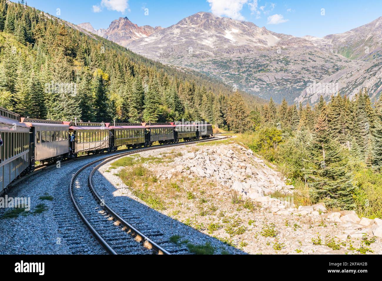Skagway, AK - September 7, 2022: The White Pass and Yukon Route train winds it's way through the mountains east of Skagway. Stock Photo