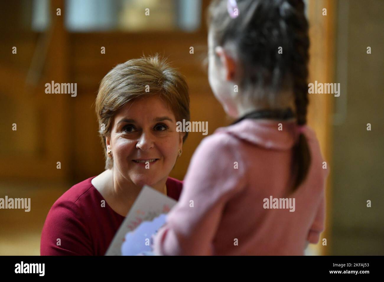 Edinburgh, Scotland, UK. 17 November 2022. PICTURED: Ava, 6, who is celebrating her 6th birthday today seen meeting seen meeting Nicola Sturgeon MSP, First Minister of Scotland and Leader of the Scottish National Party (SNP). Ava wanted to come and meet the First Minister again after she last saw the First Minister during the council elections in Kirkcaldy spending the afternoon with her during campaigning. Scenes inside the weekly session of First Ministers Questions inside the Scottish Parliament at Holyrood. Scenes showing before, during and after FMQs. Credit: Colin D Fisher Stock Photo