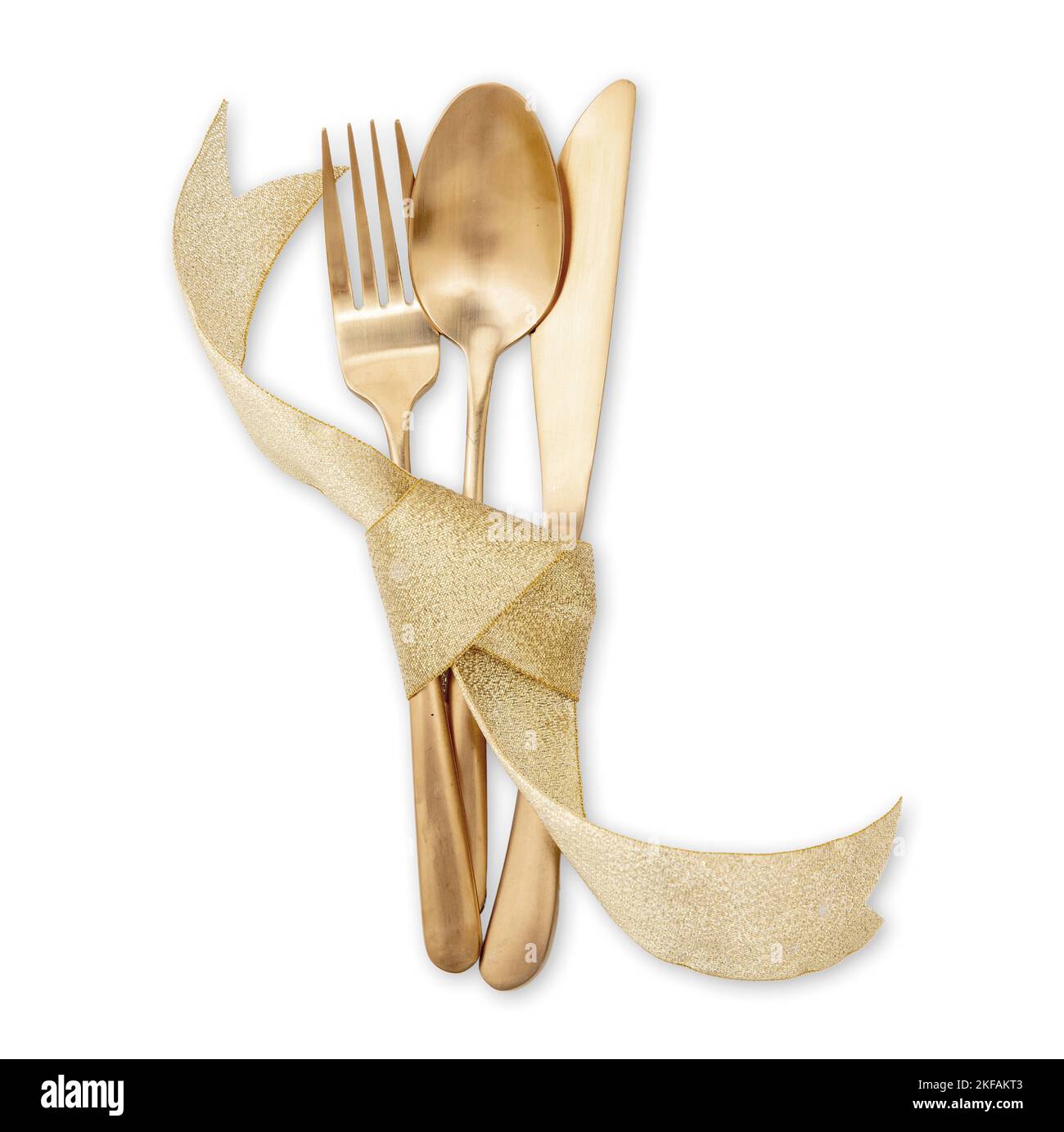 Gold cutlery and ribbon decoration isolated on white. Christmas table setting top view. Holiday celebration dinner. Stock Photo