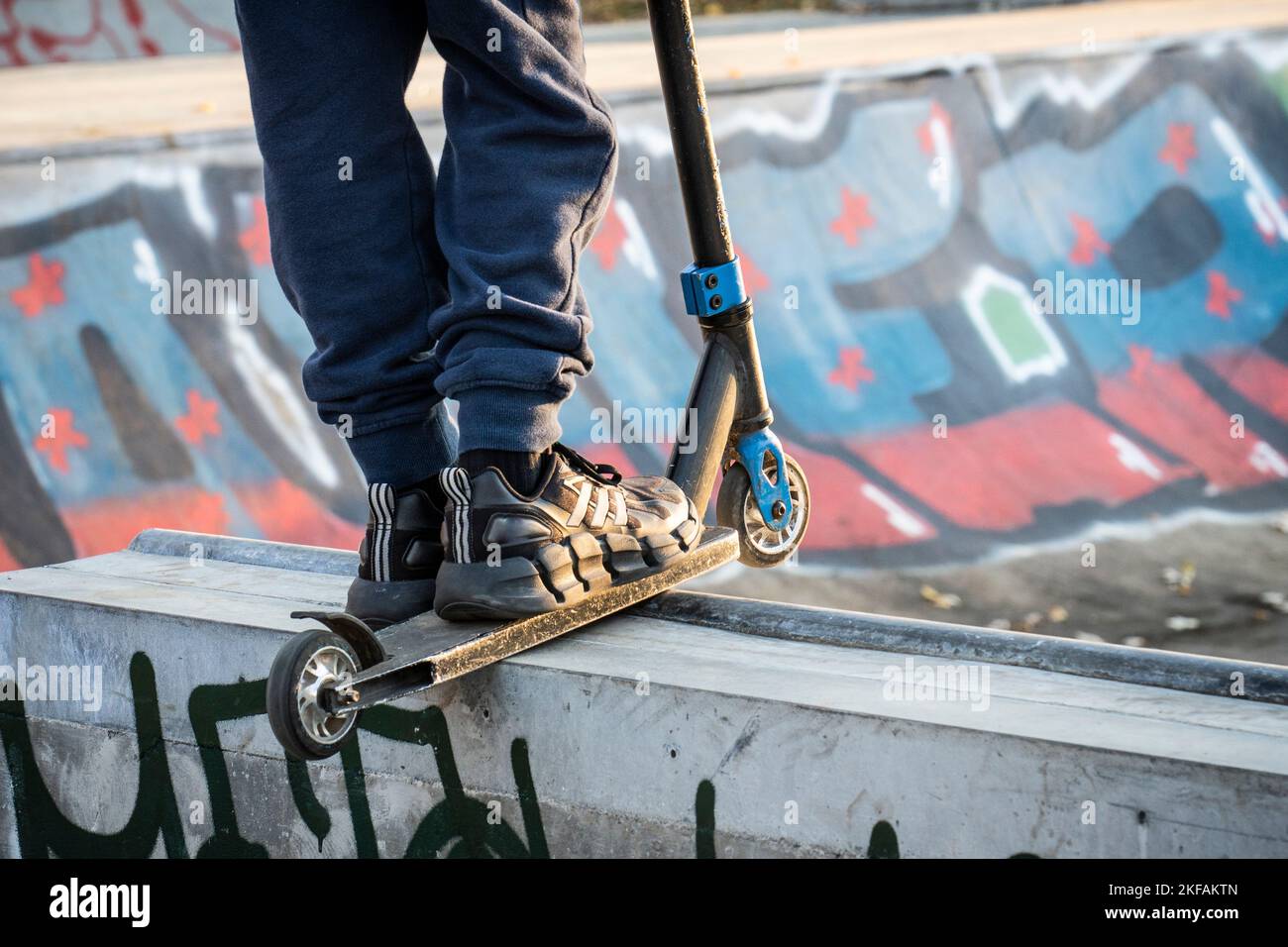 Selective cropping of a young skater practicing at a skate park. Stock Photo