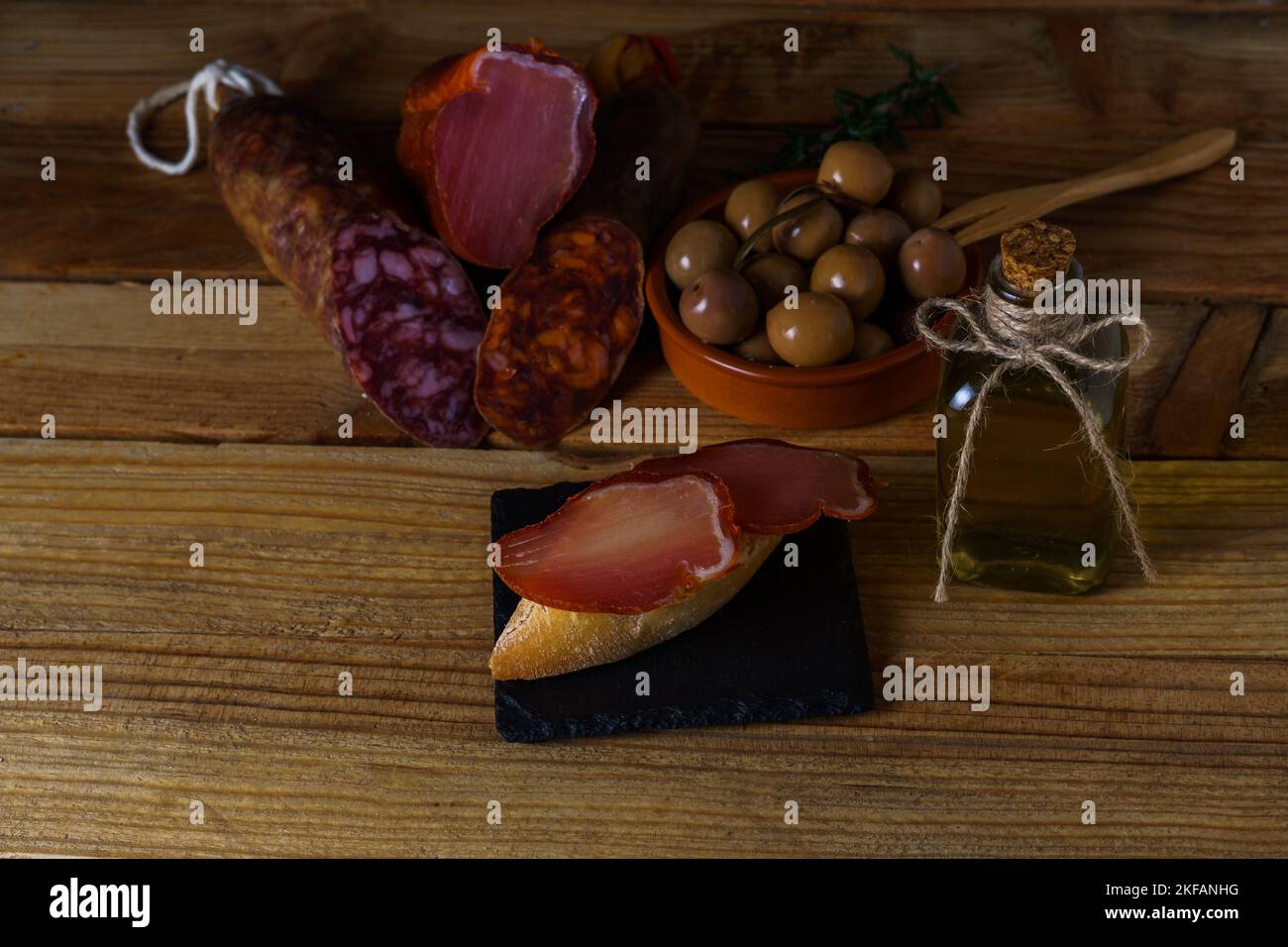 tapa of iberian loin on rustic bread with olive oil on a black slate ...