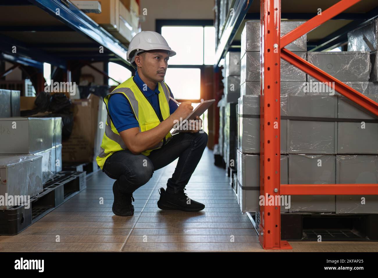 Working at warehouse. Male warehouse worker checking in storage