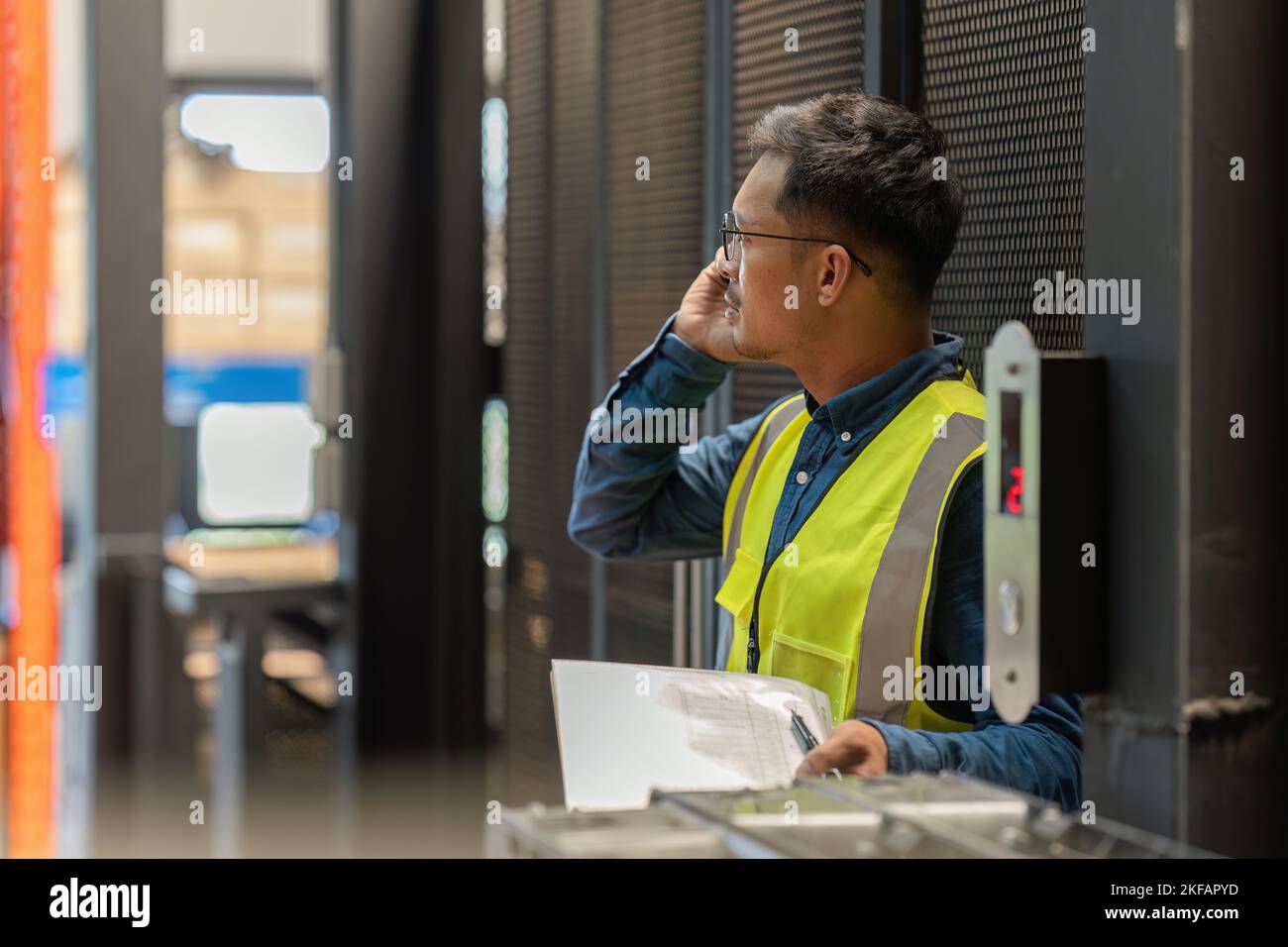 Working at warehouse. Male warehouse worker checking in storage