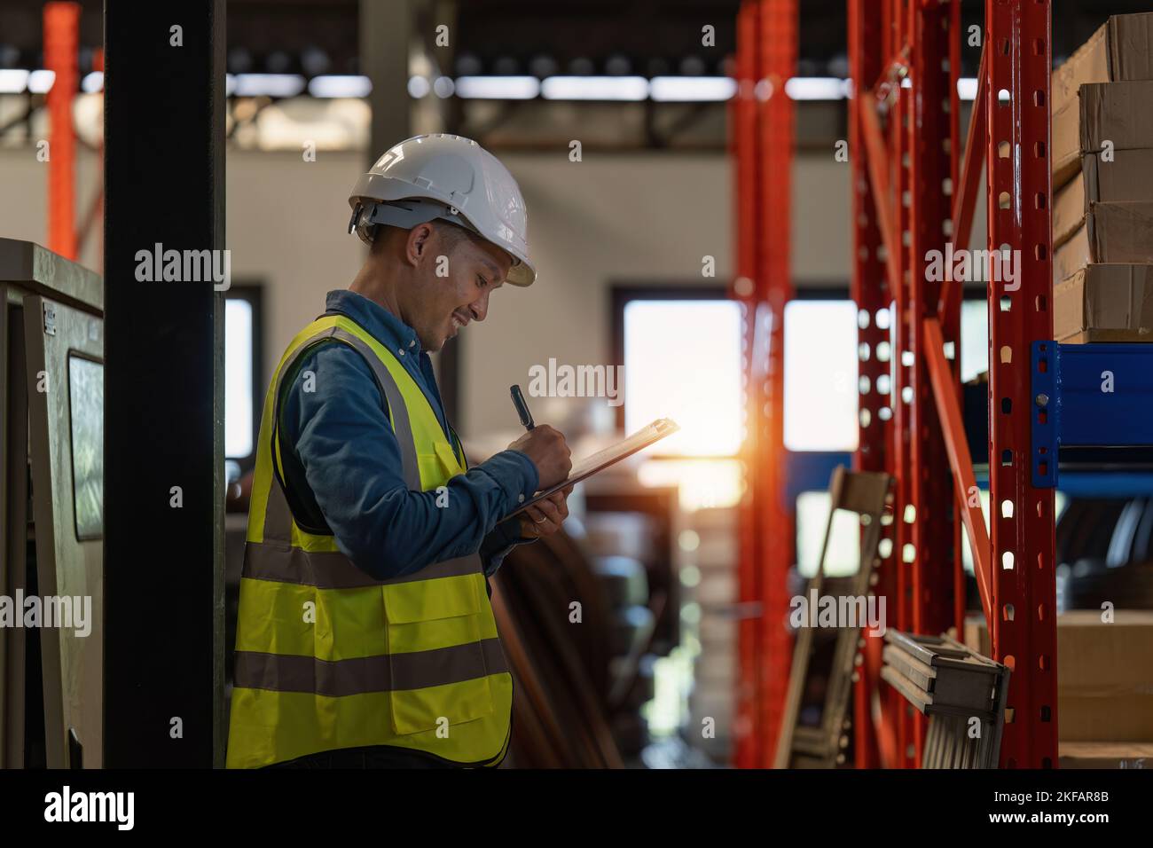 Working at warehouse. Male warehouse worker checking in storage