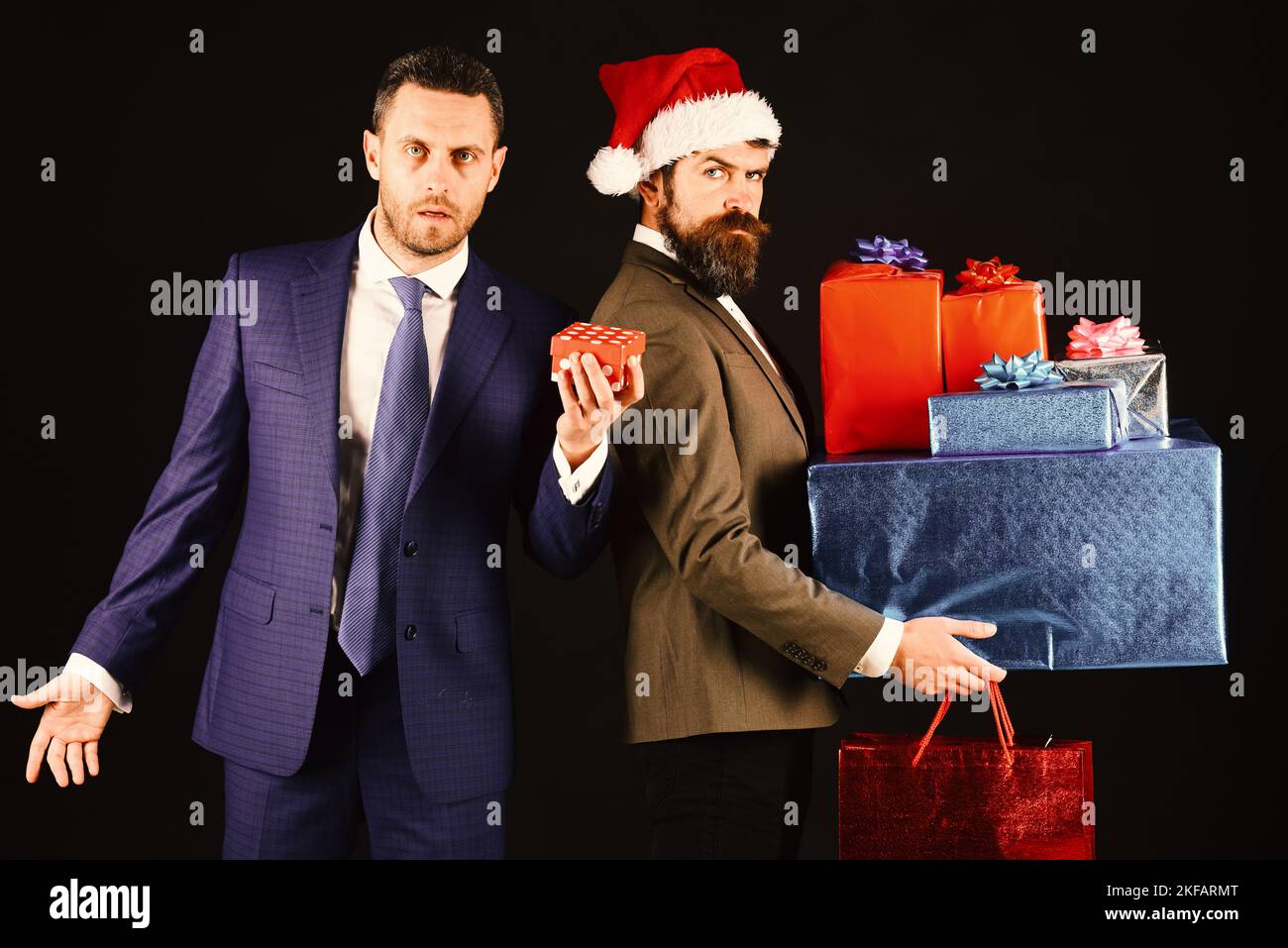 Christmas online shopping. Man in smart suit holding little box Stock Photo