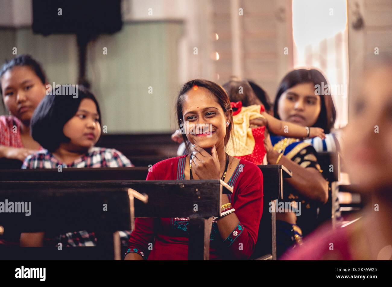 A group of Indian women sitting in a gathering in traditional Indian ...