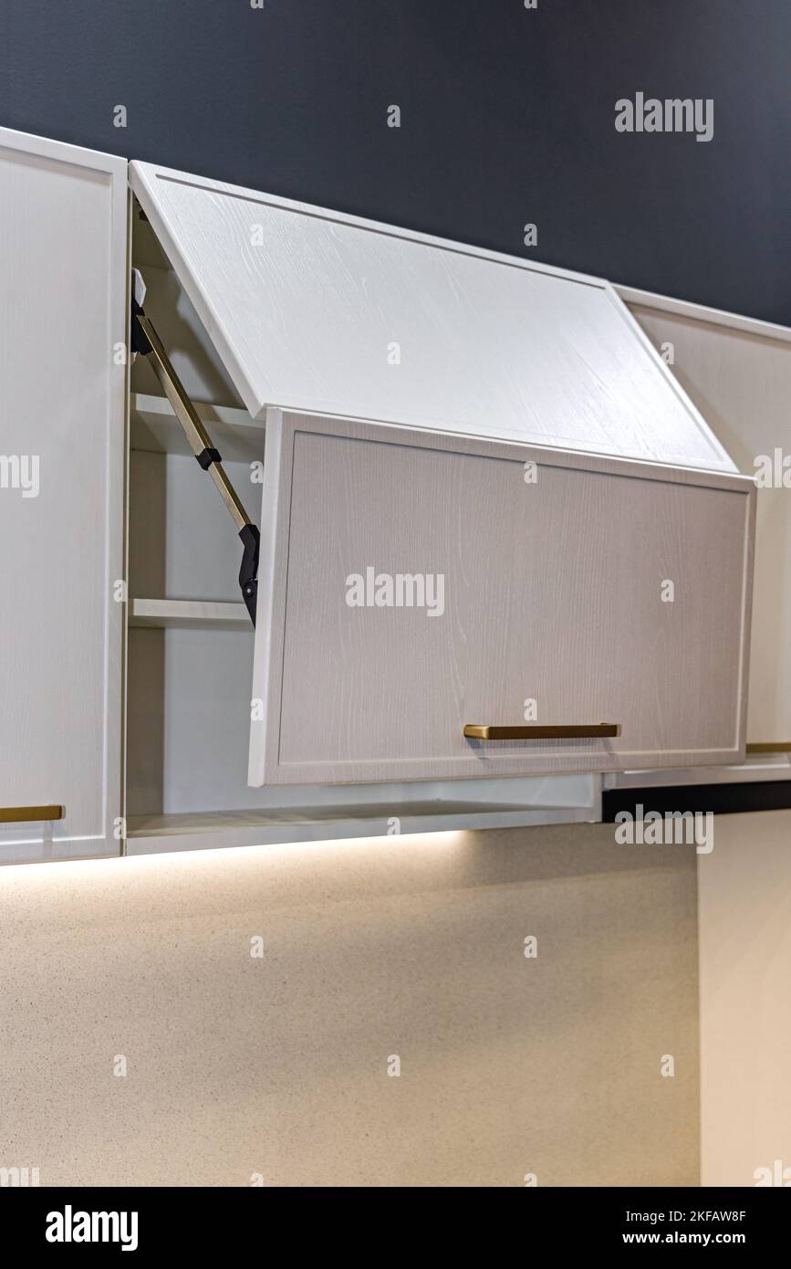 Automatic Effortless Cabinet Door Opener in Modern Kitchen Stock Photo