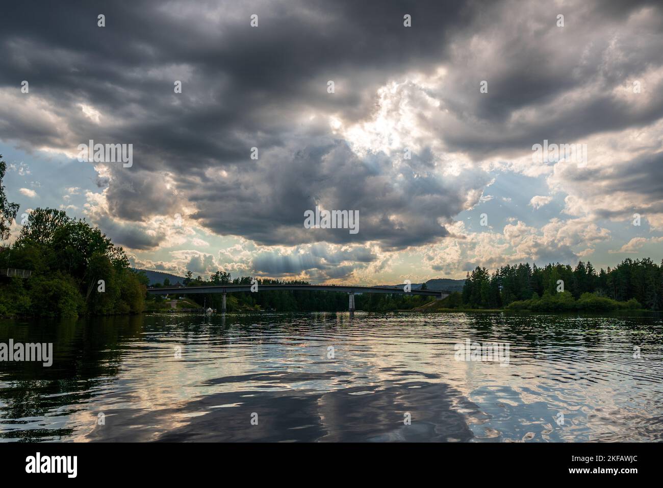 A lake under a cloudy sky at sunset Stock Photo - Alamy