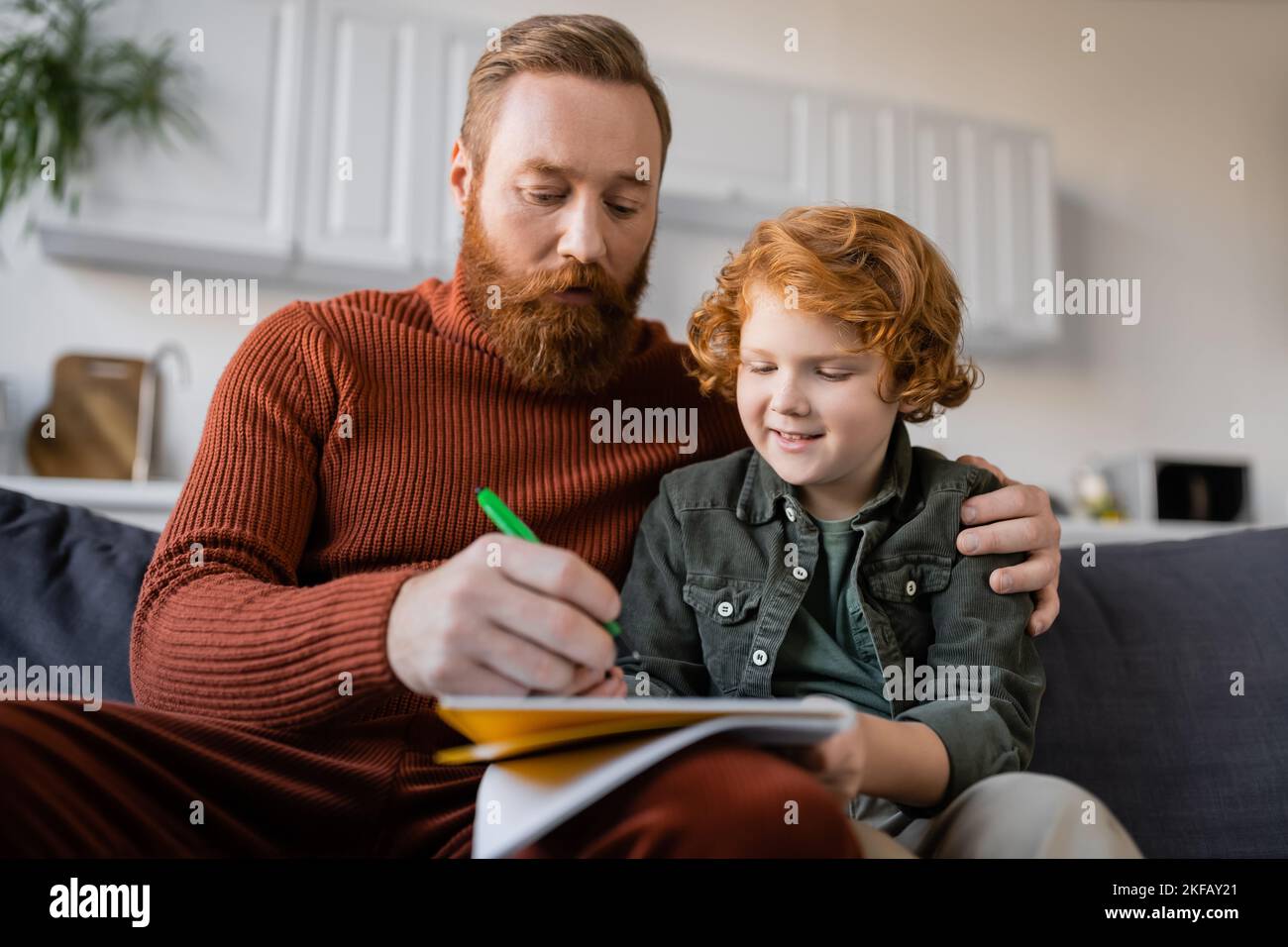 Smiling redhead kid writing hi-res stock photography and images - Alamy