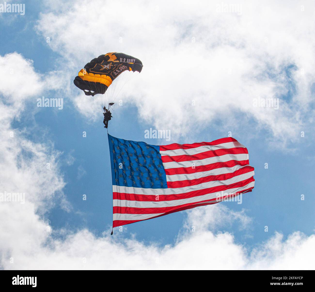 Farmingdale, New York, USA - 26 May 2022: A United States Army paratrooper on the Golden Nights Team opens up the airshow parachuting down to the grou Stock Photo