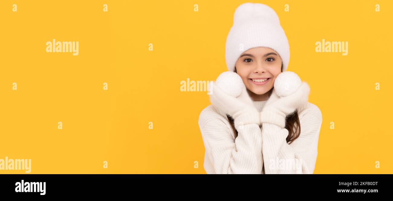 merry chistmas. happy new year. smiling child in winter hat and gloves. kid with snowballs. Banner of christmas child girl, studio kid winter portrait Stock Photo