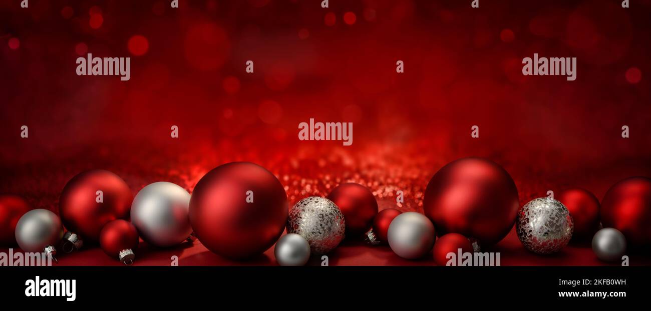 Baubles as a border on a red festive Christmas background with glittering bokeh lights, wide format with copy-space Stock Photo