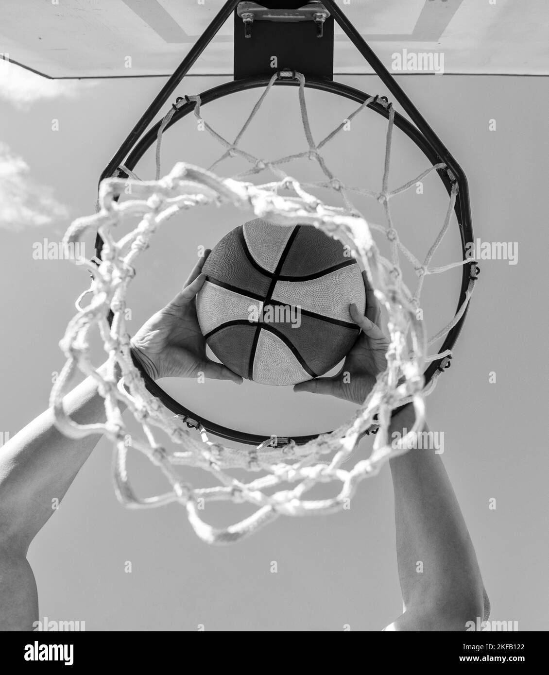 sport success. scoring while basketball game. ball goes through basket Stock Photo Alamy