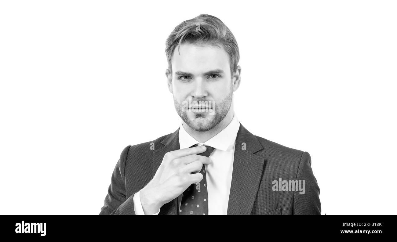 Portrait of professional employee man with serious face adjusting necktie in suit, businessman Stock Photo