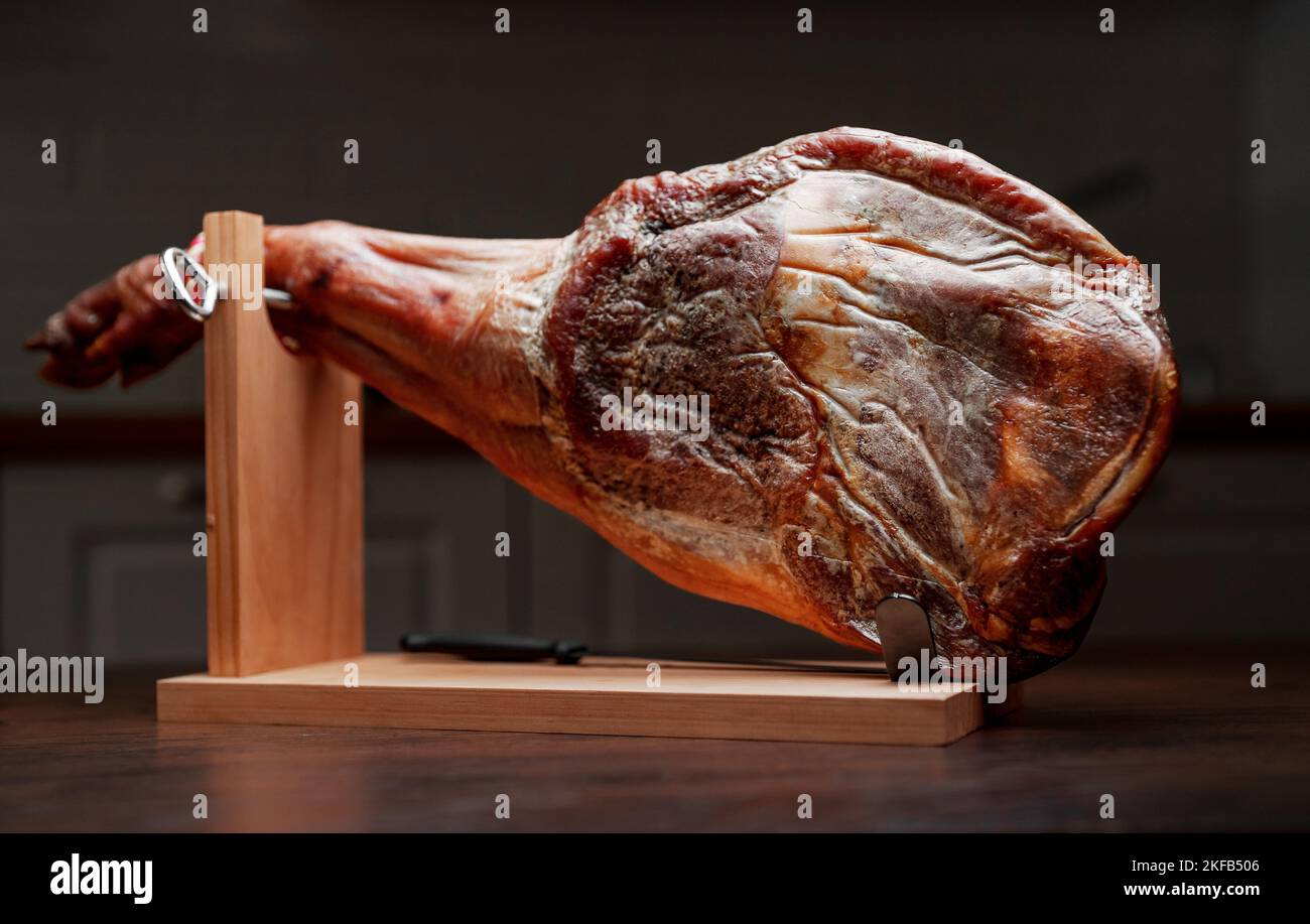 Drycured spanish ham. Jamon on a wooden stand Stock Photo Alamy