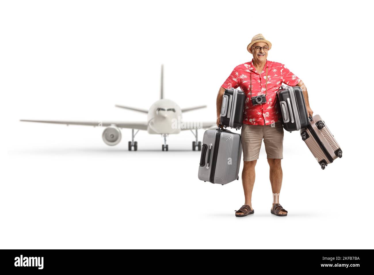 Mature male tourist with many suitcases in front of a plane isolated on white background Stock Photo