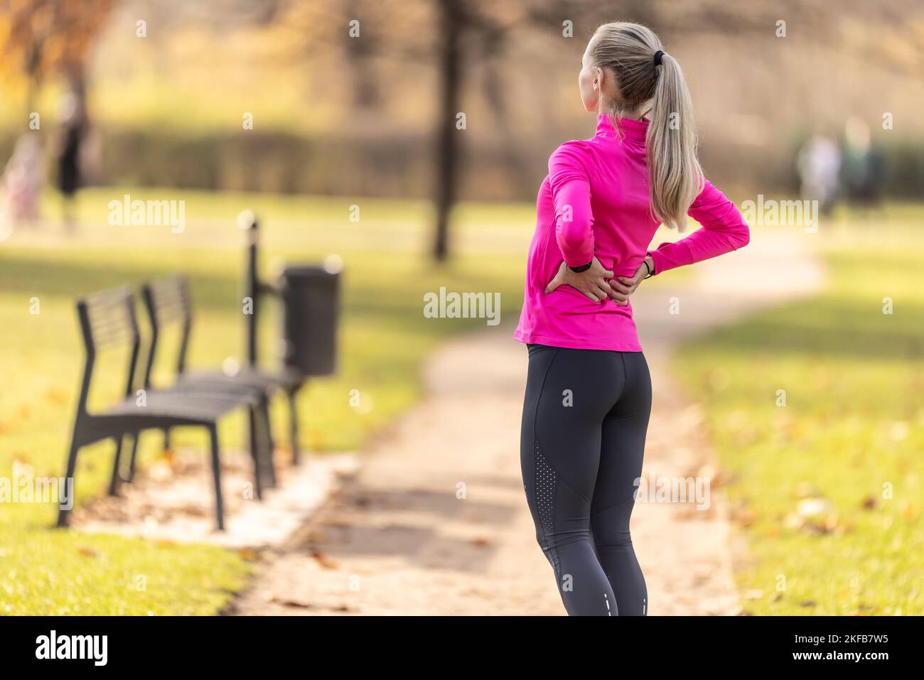 Young woman with an athletic figure and a lower back injury. Back pain