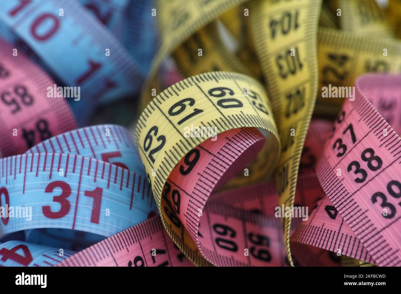 A pile of colorful measuring tapes. Close up. Stock Photo