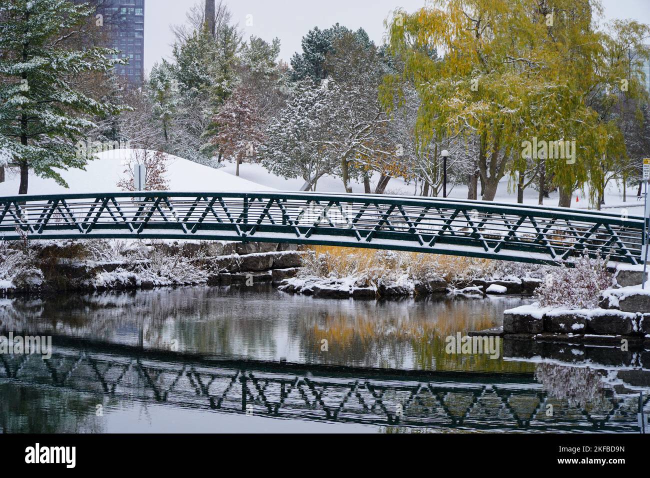 A bridge over a river in a park covered in snow in Canada Stock Photo ...